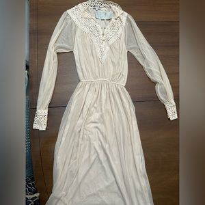 Brand new Beige Dress with see-through long sleeves. Falls to past the knee.
